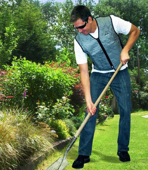 Man wearing a Chill-Its cooling vest while digging in a garden