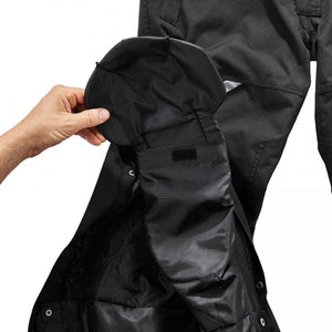 Hand opening a black cargo pocket on work trousers