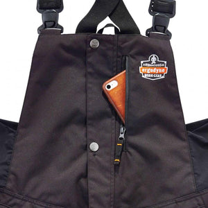 N-Ferno bib overalls featuring a zippered chest pocket with a smartphone inside and Ergodyne logo