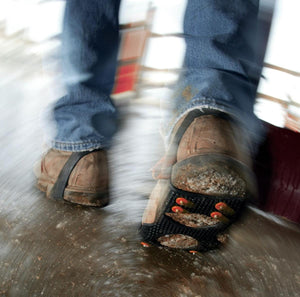 Person wearing ice cleats on boots walking on icy surface