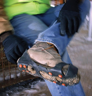 Person wearing Trex ice cleats over work boots