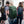 Three people walking outdoors wearing Thule backpacks