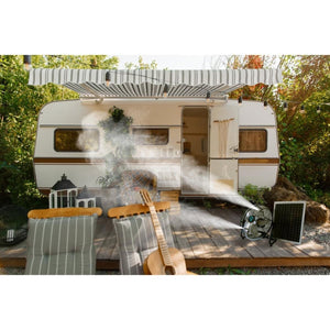 ExtremeMIST solar powered misting fan on a wooden deck in front of a camper