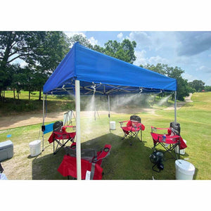 ExtremeMIST canopy tent with active water misting system over red folding chairs on a grassy field
