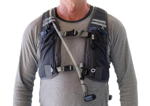 Person wearing an ExtremeMIST hydration vest with a drinking tube and nozzle
