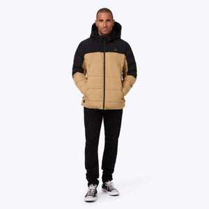 Man wearing a black and tan Mobile Warming hooded puffer jacket