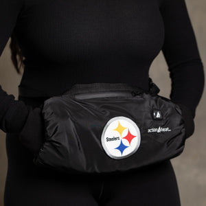 Person wearing a black ActionHeat Pittsburgh Steelers heated hand warmer muff