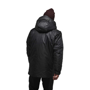 Back view of a person wearing a black Black Diamond hooded insulated jacket and a maroon beanie