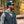 Man wearing a Mobile Cooling quilted vest and cap in a forest setting