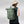 Person wearing a green Fjallraven rolltop backpack with bungee cord detail