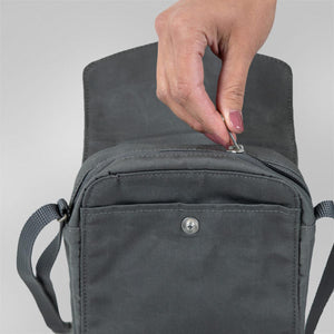 Hand pulling the zipper on a grey FjallRaven shoulder bag
