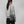 Person wearing a grey FjallRaven shoulder bag over a grey sweatshirt