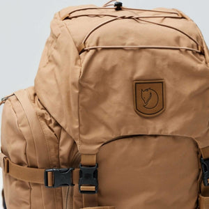 Tan FjallRaven backpack with top lid and compression straps