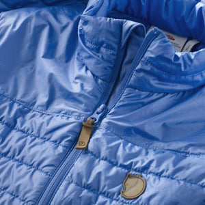 Close up of blue FjallRaven quilted jacket zipper and logo patch