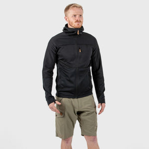 Man wearing a black FjallRaven hooded fleece jacket and olive green cargo shorts