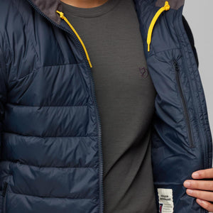 Close up of navy FjallRaven quilted jacket with yellow hood drawstrings