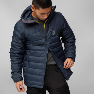 Man wearing a navy blue Fjallraven hooded puffer jacket
