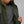 Person wearing a dark green FjallRaven quilted vest over a grey t-shirt