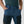 Fjallraven blue trekking trousers with black thigh pockets and hands in pockets