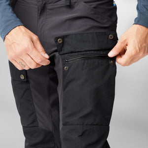 FjallRaven black trekking trousers with zippered cargo pocket and snap button closures
