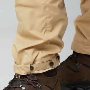 Close up of FjallRaven trouser hem with adjustable button strap and brown hiking boots