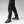FjallRaven black trekking trousers with side pockets and brown leather hiking boots