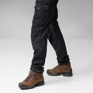 FjallRaven black trekking trousers with side pockets and brown leather hiking boots