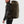 Person wearing a dark green FjallRaven backpack from the side
