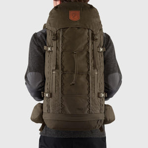 Person wearing a dark green Fjallraven Singi backpack from the back