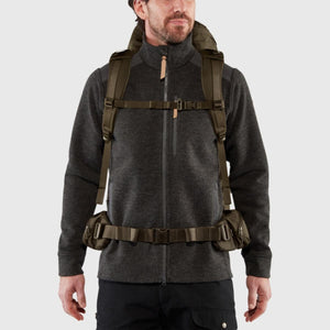 Man wearing a green FjallRaven backpack with a waist belt and chest strap