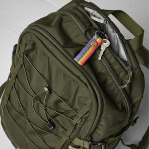 Fjallraven olive green backpack with rainbow key fob and keys attached to the zipper