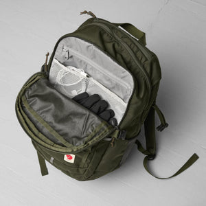 Open FjallRaven backpack showing interior mesh pocket with charging cable and black gloves