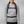 Person wearing a blue Fjallraven backpack with chest and waist straps fastened