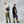 Two people wearing Fjallraven crossbody bags against a grey background