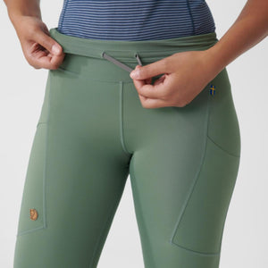 Close up of Fjallraven green leggings with drawstring waist and side pockets
