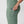 Sage green leggings with a side pocket containing a smartphone