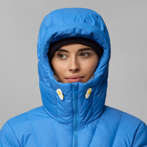 Person wearing a blue FjallRaven hooded puffer jacket with a black beanie