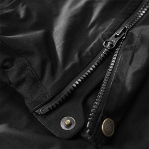 Close up of black FjallRaven jacket zipper and metal snap button