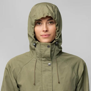 Person wearing an olive green FjallRaven hooded jacket