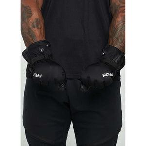 Person wearing black FNDN heated mittens with adjustable wrist straps