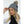 Woman wearing a grey cable knit beanie with a pom pom and integrated Bluetooth speaker
