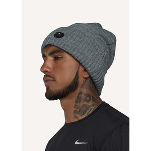 Man wearing a grey FNDN ribbed knit beanie with a circular logo patch