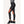 Side view of black AFNDN athletic leggings with orange grid pattern on the knees