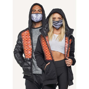 Man and woman wearing black hooded jackets with orange grid patterns and patterned face masks