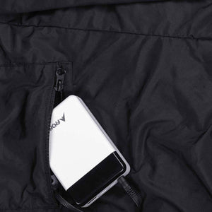 FNDN power bank plugged into a zippered pocket on a black garment