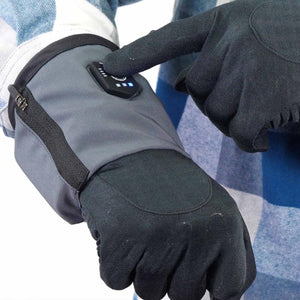 FNDN heated glove with finger pressing the power button on the wrist cuff