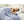 Person sleeping under a blue heated blanket with a digital controller