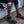 Person inserting a Mobile Warming battery pack into the pocket of a grey and orange heated sock