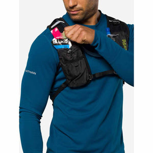 Person wearing a Nathan hydration vest with an energy gel in the front pocket