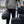 Person holding multiple black Thule travel bags and luggage